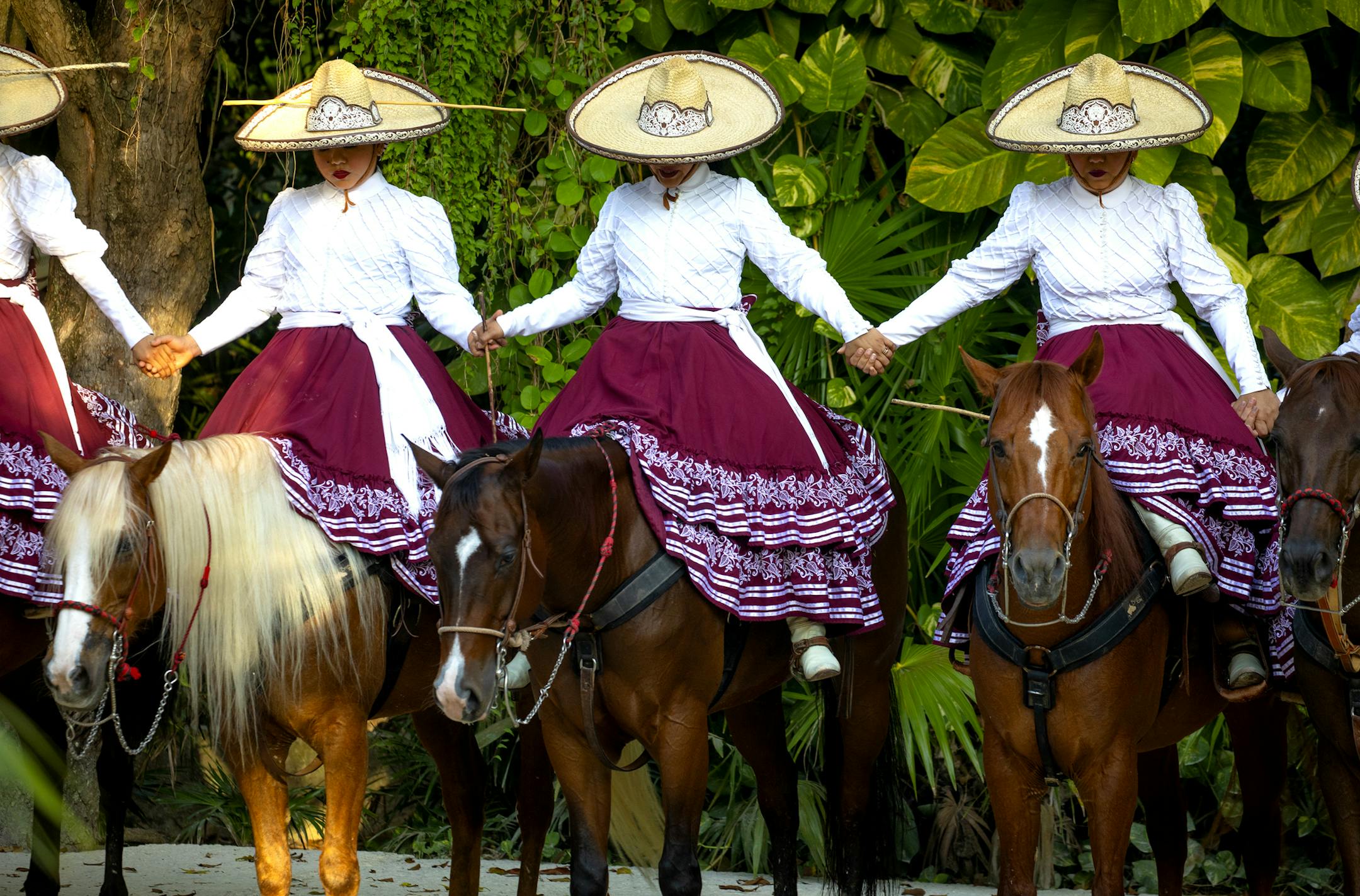 Young female charros held hands in prayer before performing in a Charreria at Xcaret Park. ] ELIZABETH FLORES &#x2022; liz.flores@startribune.com