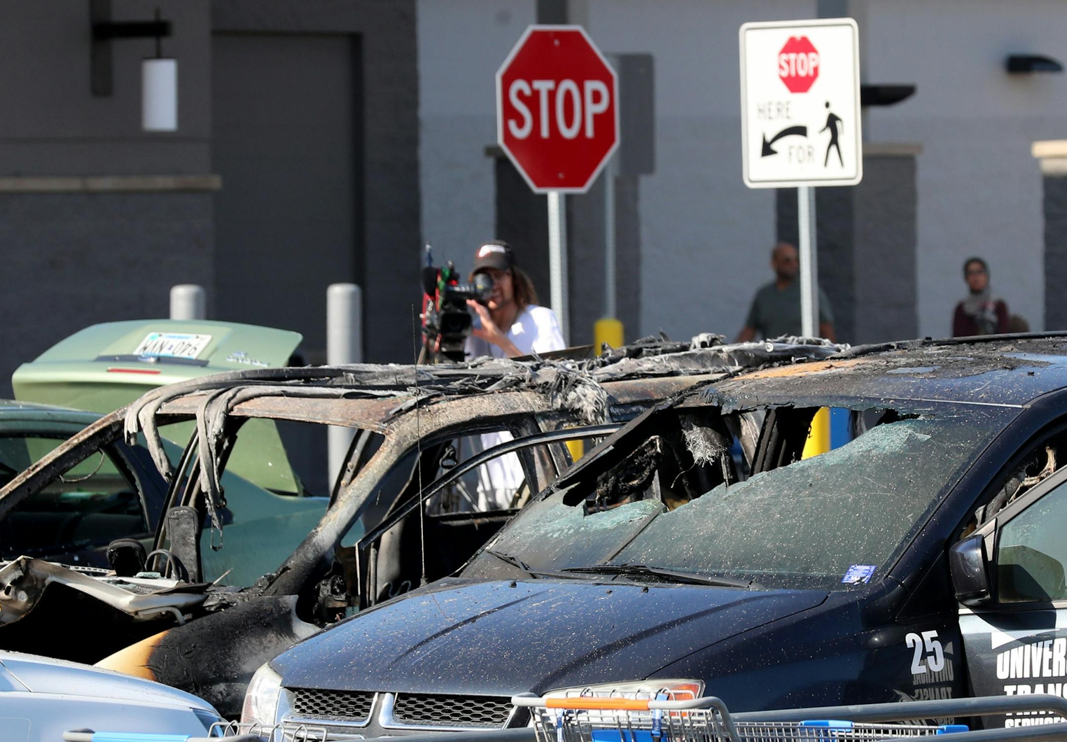 A car fire at a Fridley Walmart engulfed three vehicles and left two young passengers injured in a taxi van parked next to the vehicle where the fire originated Tuesday, Aug. 6, 2019, in Fridley, MN. Two of the three charred vehicles, including the van (foreground) where two children were injured in the fire.