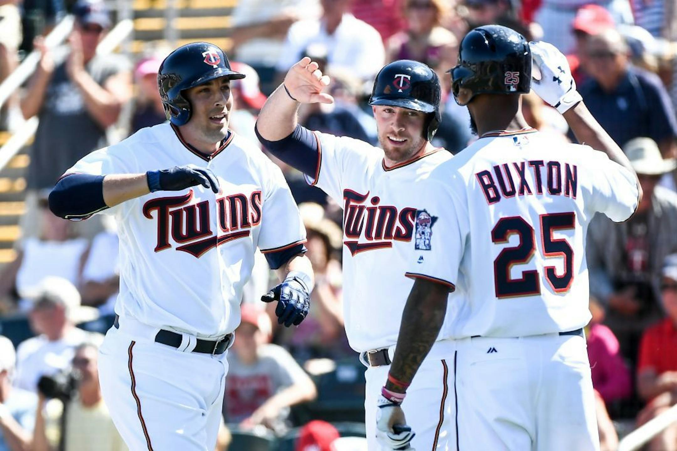 Minnesota Twins catcher Jason Castro (21) celebrated with catcher Chris Gimenez and outfielder Byron Buxton after Castro's 2-run home run in the bottom of the second. Gimenez score on the play.