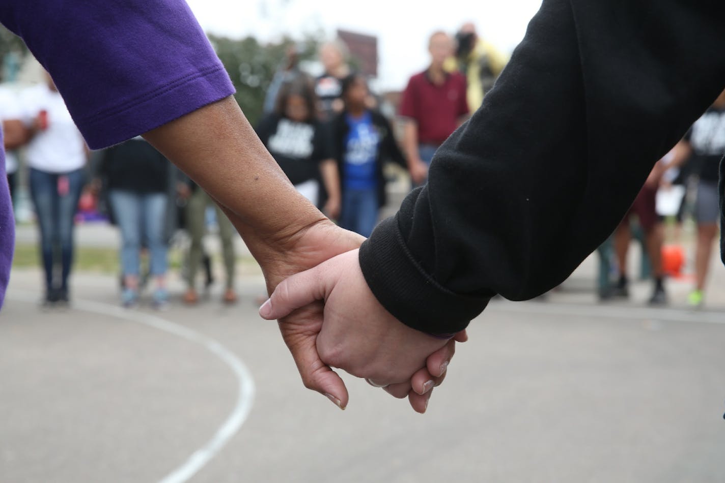 Participants joined hands and said a prayer as they prepared for the Black Lives Matter march Saturday at Hamline Park in St. Paul.