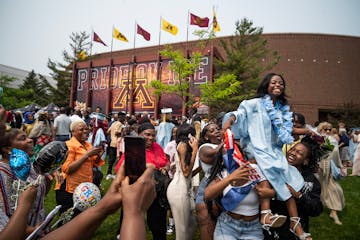Vametta Marie Ngungkpan is held aloft by friends after she exited the graduation ceremony for Blaine High School at the University of Minnesota's 3M A