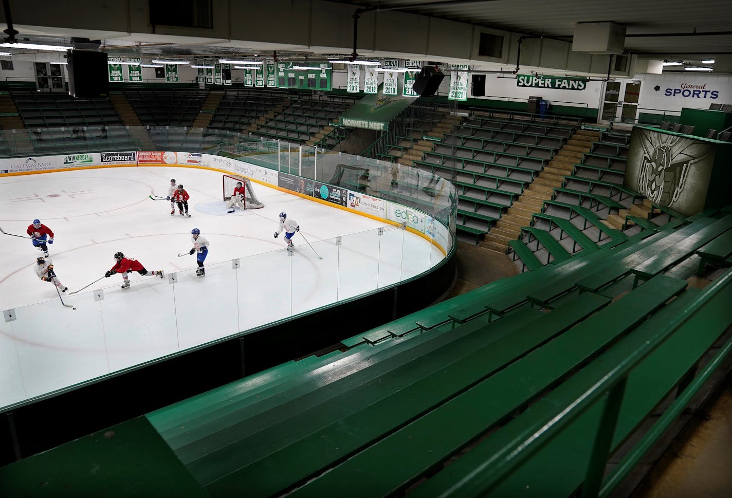 Surrounded by old, wooden bleachers, Breakaway Academy 5th graders practice hockey in the West rink at the City of Edina's aged Braemar Arena-- the kind of facility suburbs are struggling to keep up with the cost of repairs so they're taking a play from outstate Minnesota and asking the legislature for permission to collect local sales tax Thursday, Feb. 3, 2022 in Edina, Minn.  ] DAVID JOLES • david.joles@startribune.com