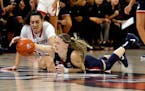 UConn's Paige Bueckers, right, tries to grab the ball ahead of North Carolina State's Mimi Collins during a game in 2023.