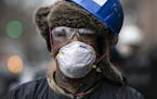 Patricio Francisco, a construction worker, wears protective gear and a face mask as he takes a break from work in the Bedford-Stuyvesant neighborhood 