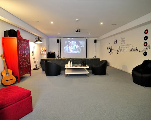 The Gallery Hostel movie room has a large projection screen and comfortable seating.