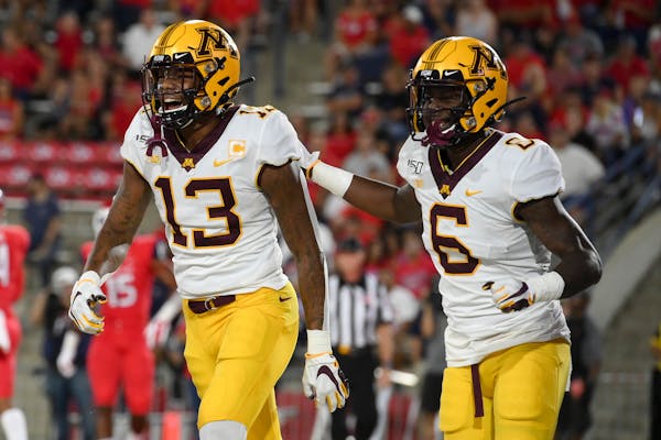 Gophers wide receivers Rashod Bateman (13) and Tyler Johnson (6) celebrated after a touchdown by Bateman on the opening drive vs. Fresno State earlier