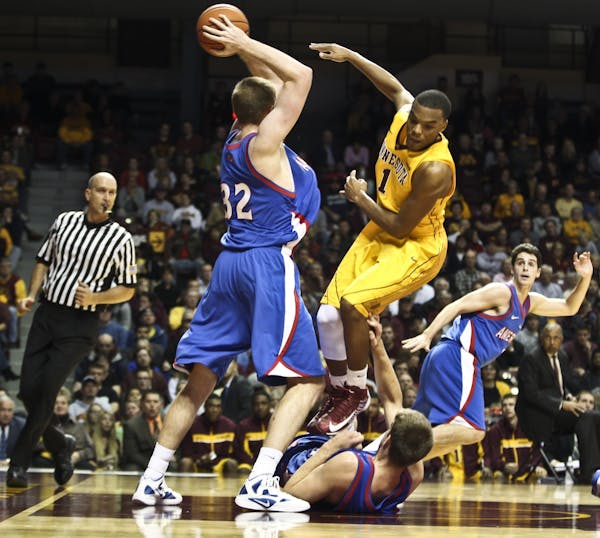 Andre Hollins leaps over an American University player in the second half.