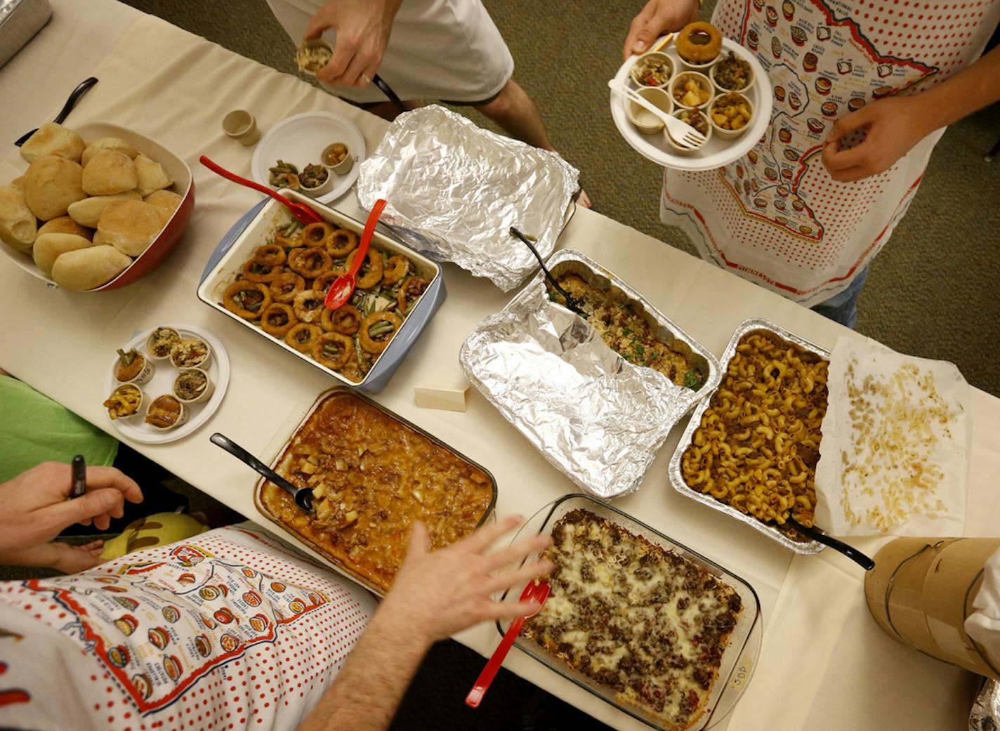 Judges filled up their sample cups at the Holland Neighborhood's 11th Annual Hotdish Revolution at St Maron's Cedars Hall in Northeast Minneapolis. ] CARLOS GONZALEZ cgonzalez@startribune.com, April 12, 2015, Minneapolis, MN, St Maron's Cedars Hall, Holland Neighborhood's 11th Annual Hotdish Revolution, featuring celebrity judges and music, plus entries into hotdish categories: spicy, vegetarian, tater tot excellence, kids, dar good, fins & feathers. There is also a Jello comptition.