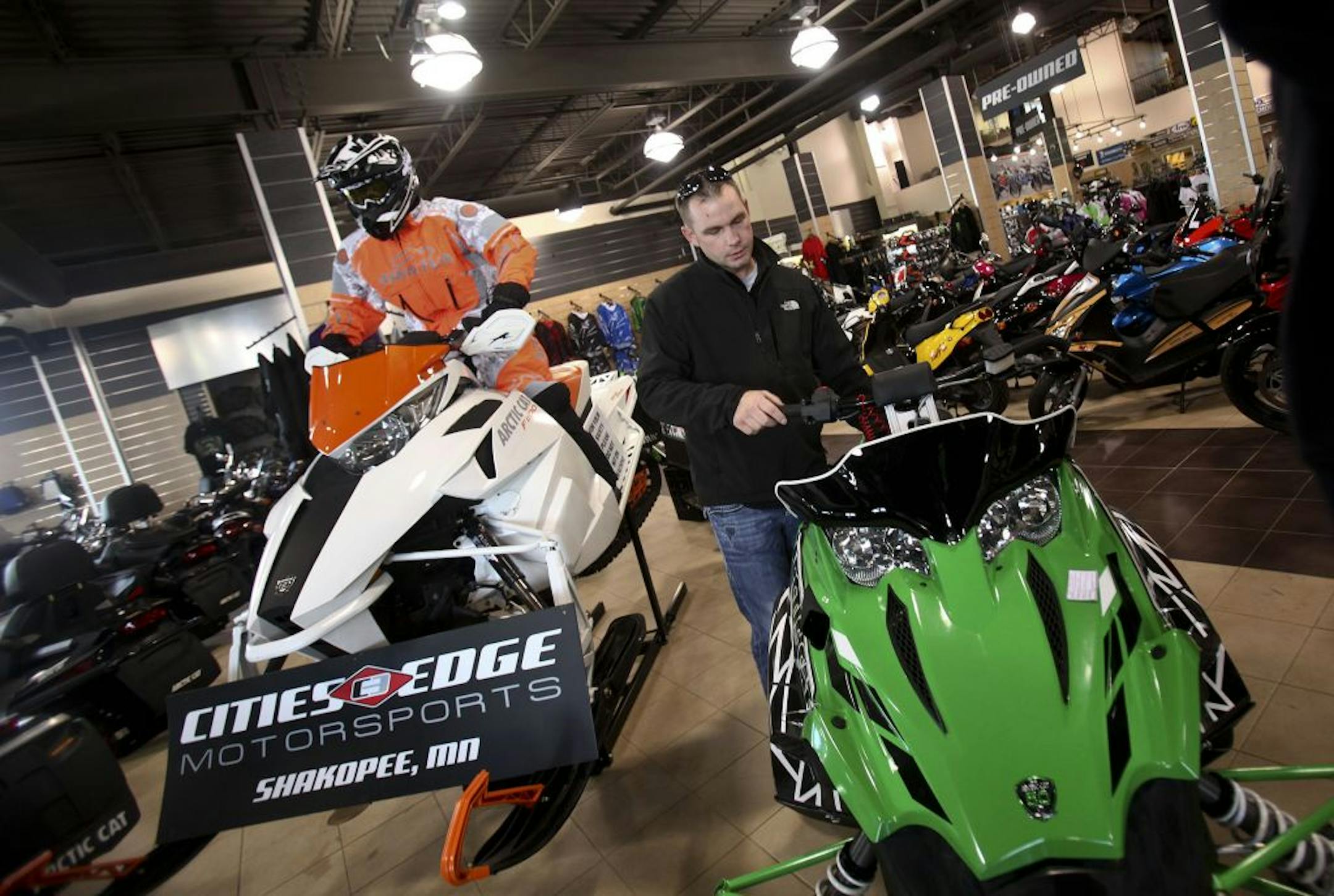 At Cities Edge Motorsports, customer Brandon Winter looked at one of the new Arctic Cats in Shakopee Thursday, October 27, 2011
