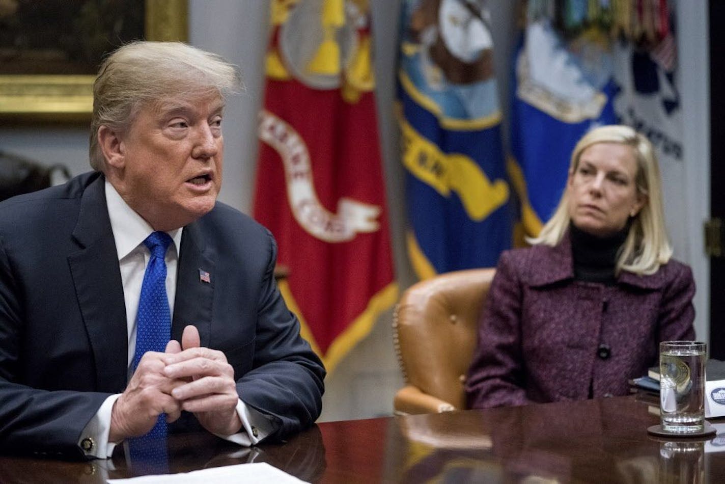 FILE- In this Thursday, Jan. 4, 2018, file photo, President Donald Trump, accompanied by Secretary of Homeland Security Kirstjen Nielsen, right, speaks during a meeting with Republican Senators on immigration in the Roosevelt Room at the White House in Washington.