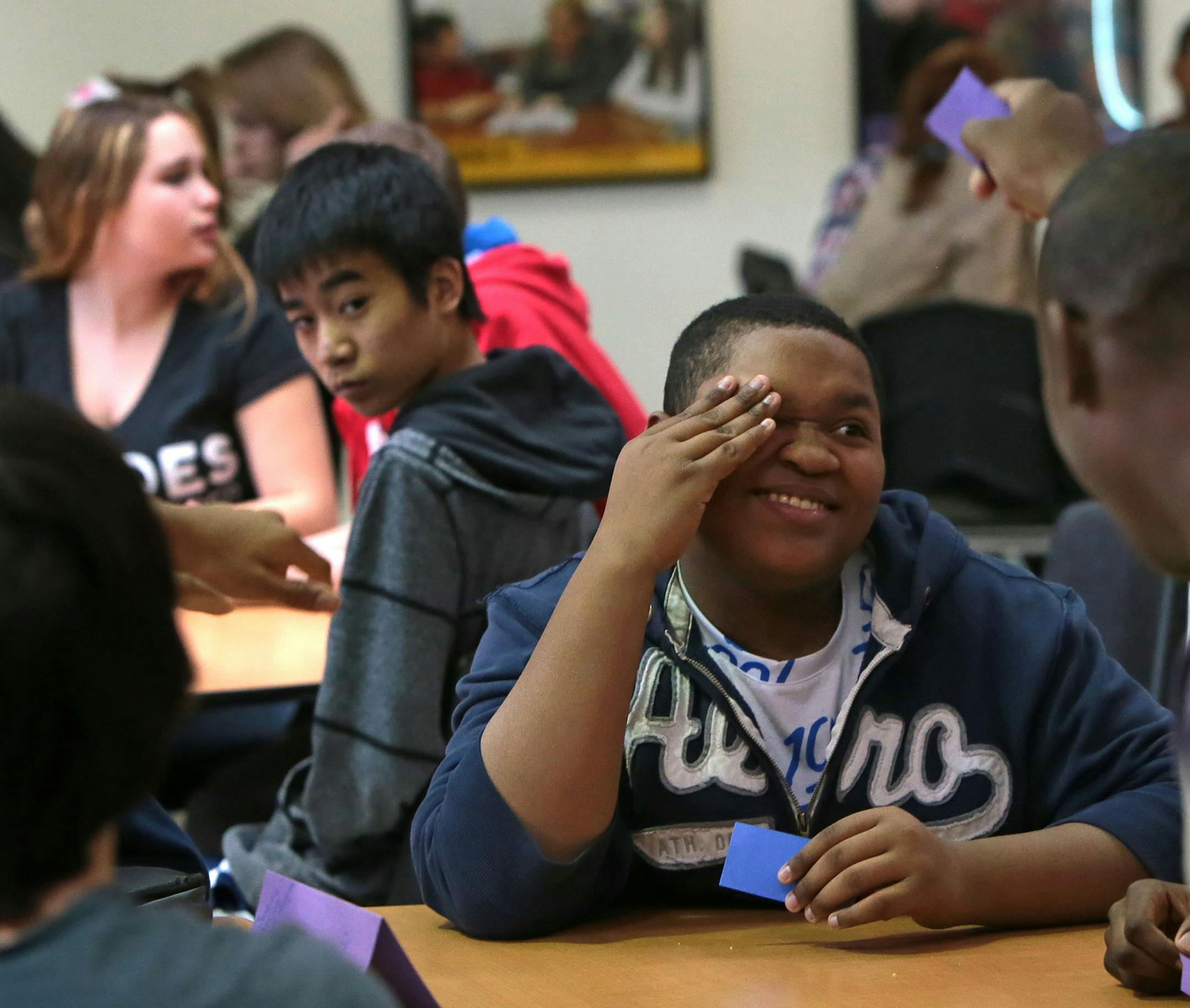 "I am uncomfortable. I am not used to this," said Kyle Johnson, 14, who cringes as he realizes his blue card does not match the purple color of his usual lunch table friends on Friday, Feb. 13, 2015, at Rogers Middle School in Affton, Mo. The school participated in National No One Eats Alone Day by encouraging students to talk to kids outside of their immediate social circle by switching up lunch seating. (Laurie Skrivan/St. Louis Post-Dispatch/TNS)