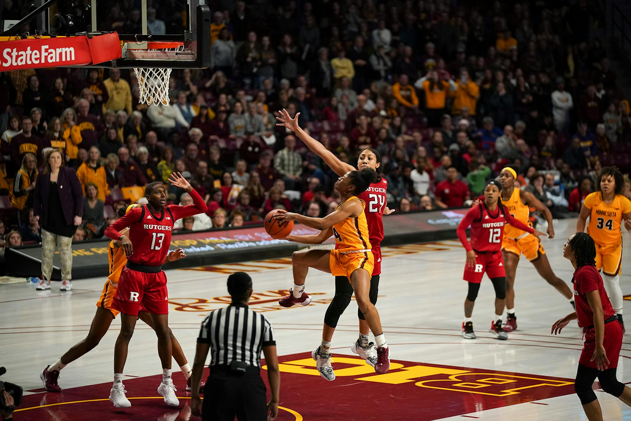 Minnesota Gophers guard Jasmine Powell (4) was fouled by Rutgers Scarlet Knights guard Arella Guirantes (24) going to the basket in the second overtime.