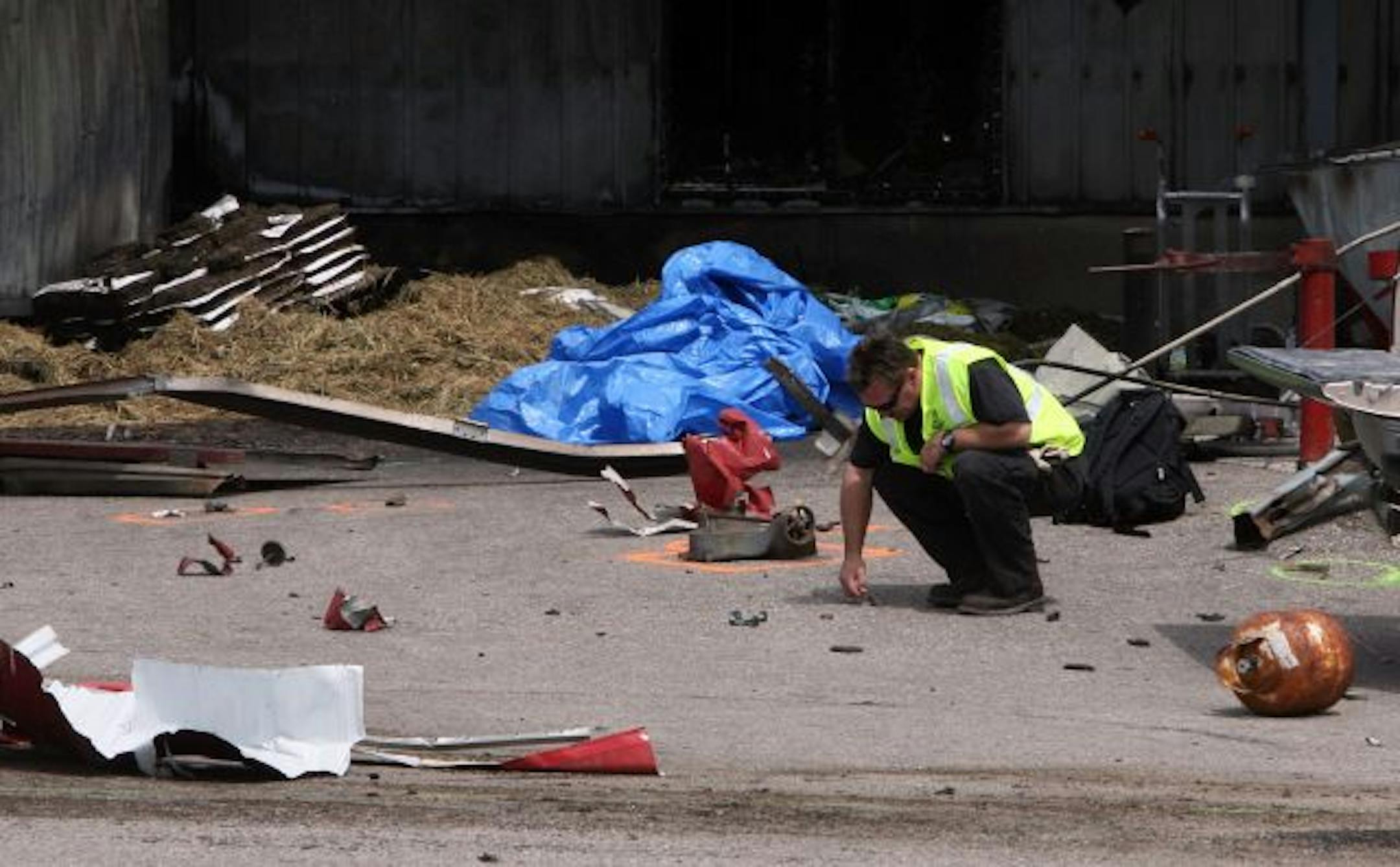 An investigator looked for clues Thursday after a 100-pound propane tank exploded Wednesday at Waconia Farm and Home Supply. The blast killed Waconia High School student Ryan John Samuelson, injured a young bystander and severely damaged the business.