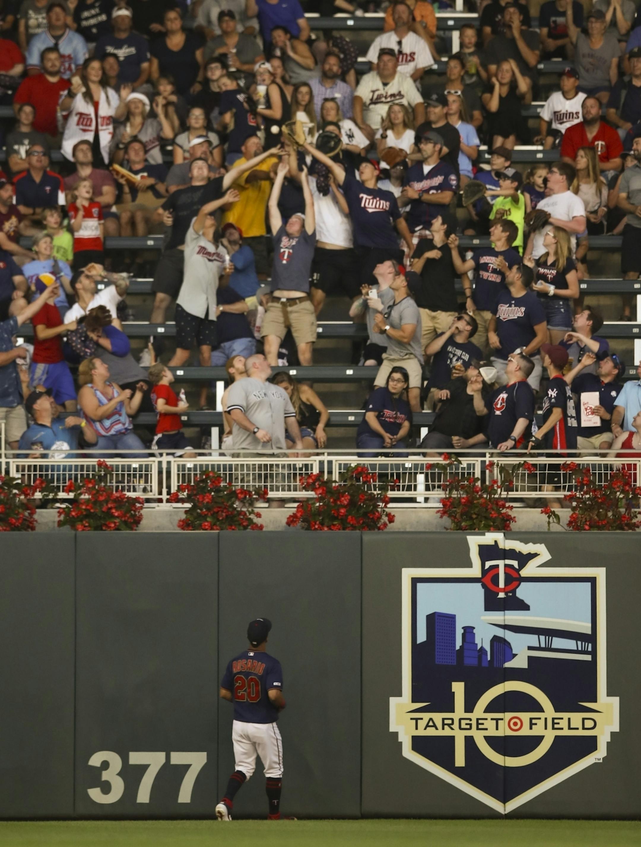Minnesota Twins left fielder Eddie Rosario (20) watched New York Yankees Gleyber Torres' third inning home fall in the stands.