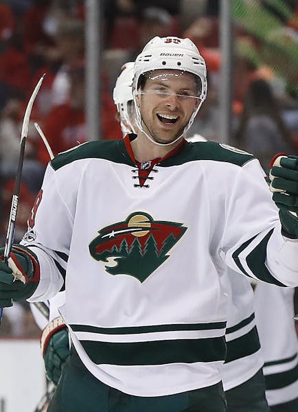 Minnesota Wild defenseman Nate Prosser celebrates his goal against the Detroit Red Wings in the second period of an NHL hockey game Sunday, March 26, 