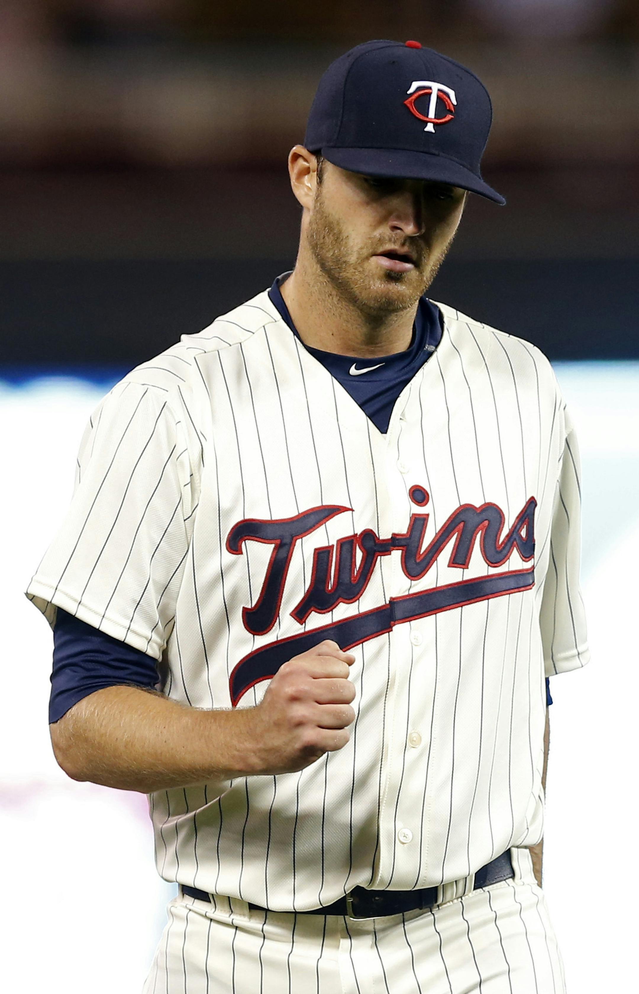 Minnesota Twins relief pitcher A.J. Achter celebrates the final out as the Twins beat the Texas Rangers 11-1 in a baseball game, Wednesday, Aug. 12, 2015, in Minneapolis. (AP Photo/Jim Mone) ORG XMIT: MNJM10