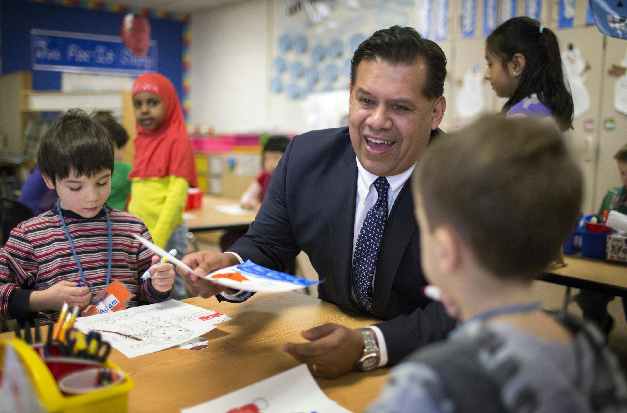 John Garcia, principal of Cedar Park STEM school in Apple Valley, chats with kindergartners before the start of school. ] Since Garcia has been at the helm, the school, considered racially identifiable by the state with more than half of students receiving free/reduced lunch, has made a dramatic shift. Once, no one wanted to say they taught or attended the school, Garcia said, and now it's a place of pride, winning many honors, including "Celebration School" status by the state. BRIAN PETERSON &