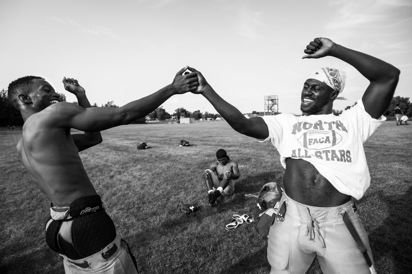 Brayon McCoy, left, of Rock Hill, South Carolina, and Denzel Washington, of Live Oak, Florida, high fived before breaking out into an impromptu wrestling match with teammates after a fall camp practice in mid-August. ] Aaron Lavinsky &#x2022; aaron.lavinsky@startribune.com Photos to accompany a story on the Mesabi Range College Football team in Virginia, Minnesota. The team, which consists mostly of black athletes recruited from around the country, struggles to find its place in mostly-white min