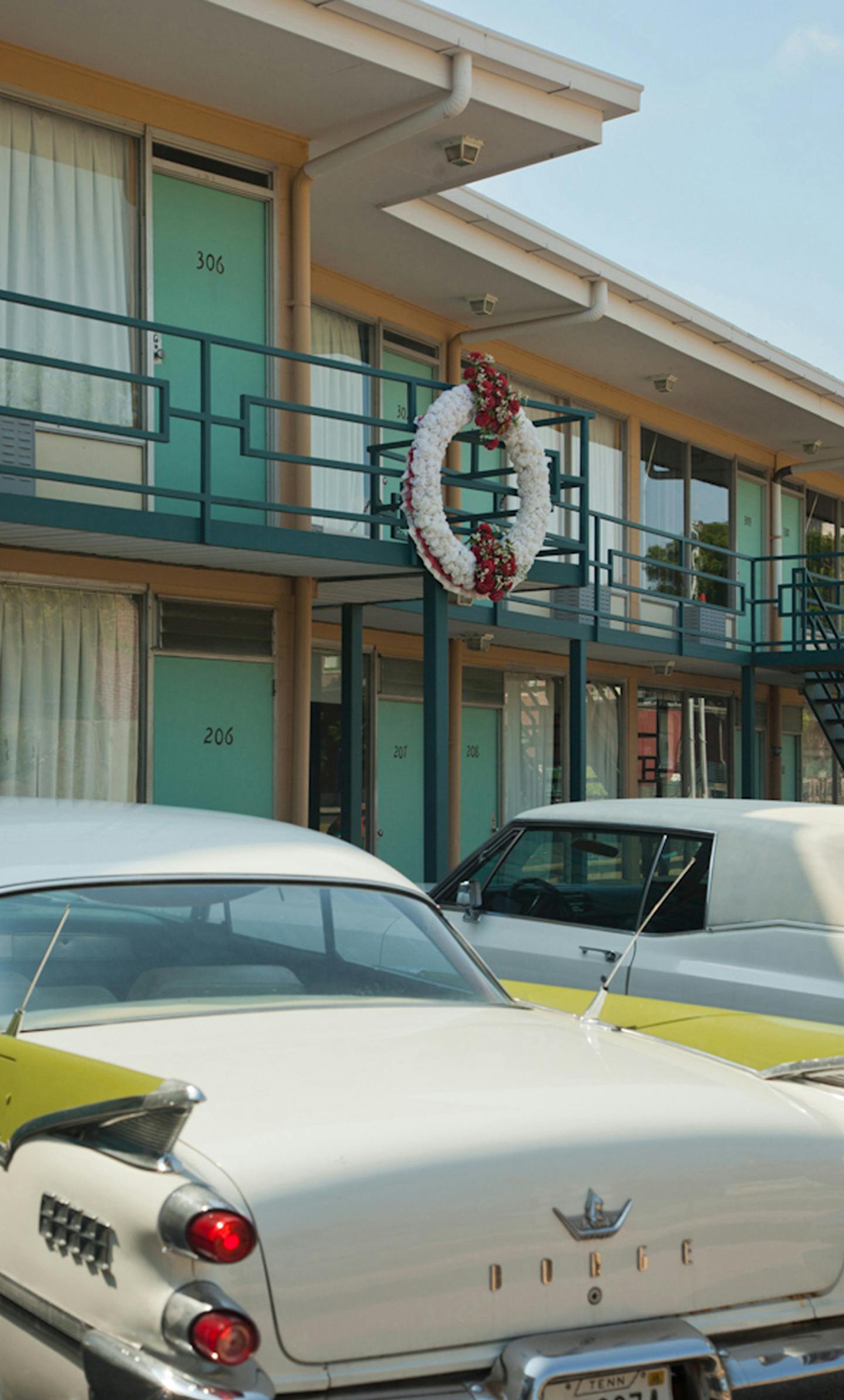 Vintage cars from the 1960s sit parked beneath the motel balcony on which Martin Luther King, Jr. was standing when he was assassinated 50 years ago, in 1968. The National Civil Rights Museum surrounds the old motel. (National Civil Rights Museum)