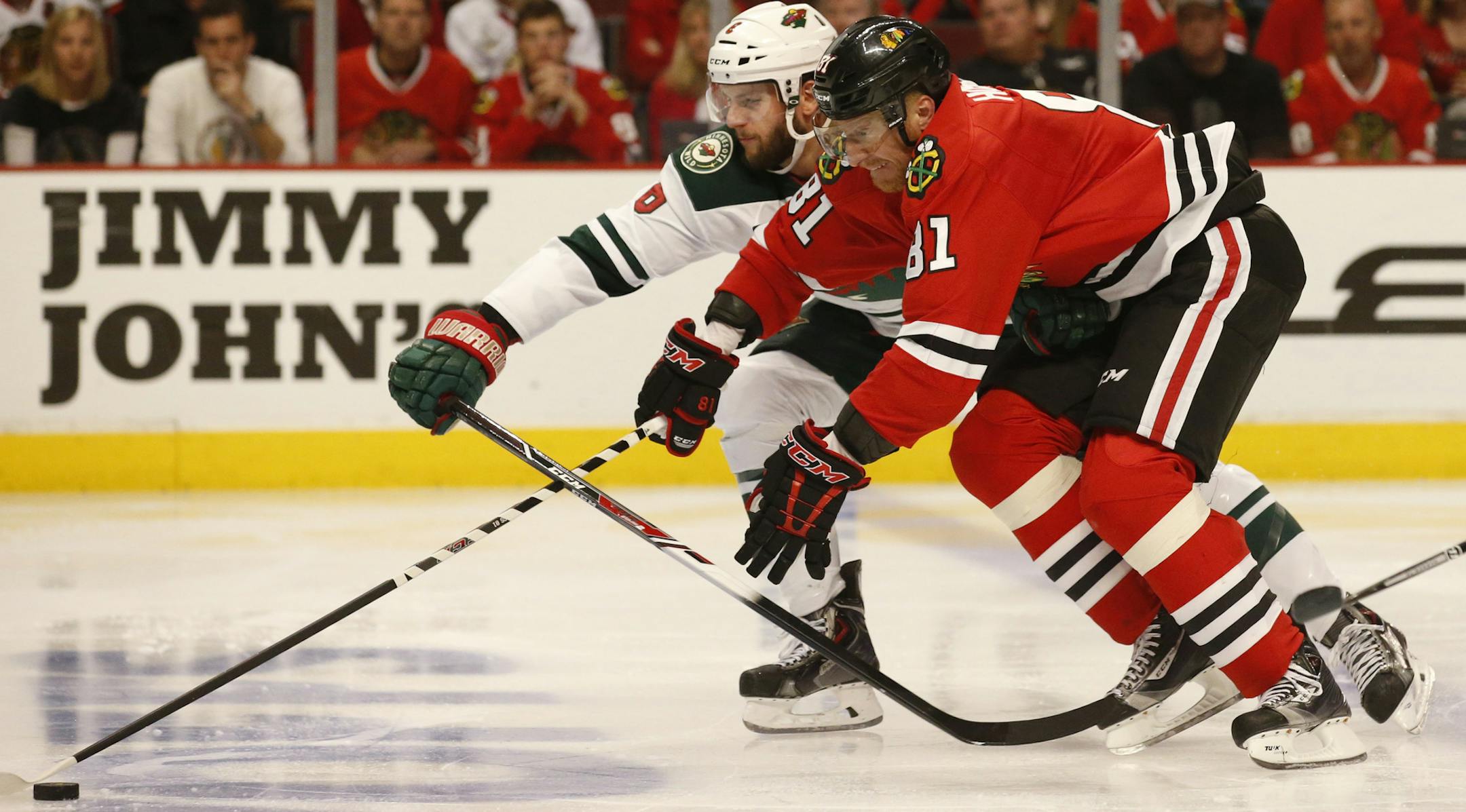 Minnesota Wild defenseman Marco Scandella (6) and Chicago Blackhawks right wing Marian Hossa (81) chase a puck during the second period of their game Sunday at the United Center. ] CARLOS GONZALEZ cgonzalez@startribune.com - May 11, 2014, Chicago, Illinois, United Center, NHL, Minnesota Wild vs. Chicago Blackhawks, Stanley Cup Playoffs Round 2, Game 5