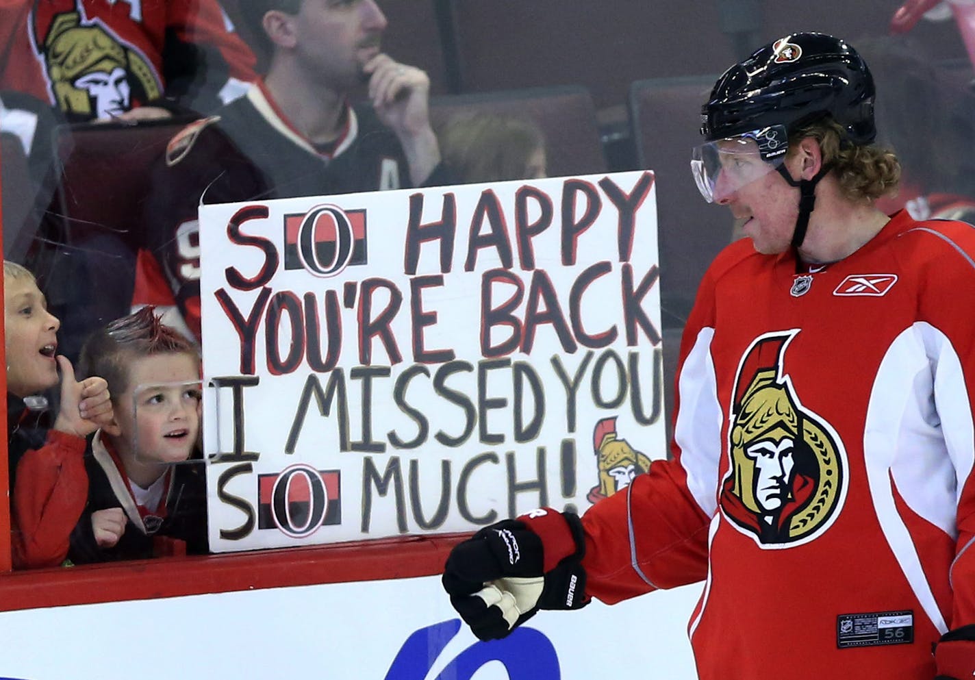 FILE - In a Sunday, Jan. 13, 2013 file photo, Ottawa Senators team captain Daniel Alfredsson acknowledges two young fans who show their appreciation for his team coming back after the NHL hockey lockout ended at training camp in Ottawa, Ontario. The lockout that lasted 119 days has ended, the new collective bargaining agreement is in place and the NHL is finally about to play games again after hastily arranged week-long training camps around the league. (AP Photo/The Canadian Press, Fred Chartra