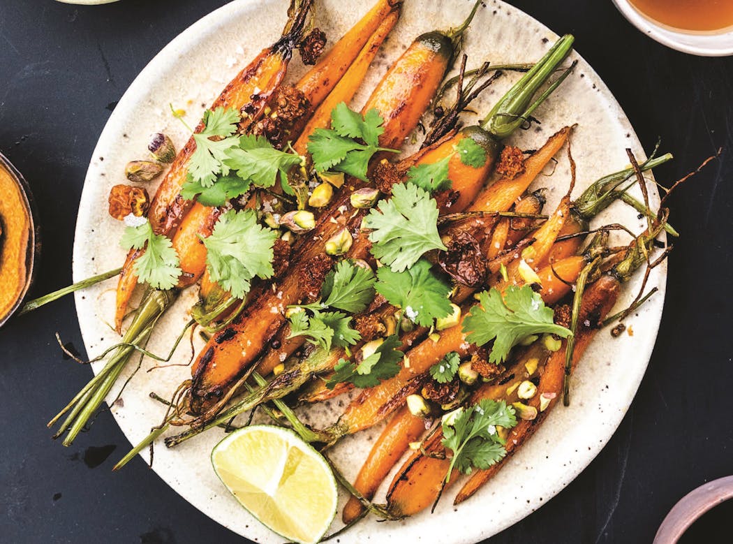 Top caramelized carrots with coriander, dried berries and pistachios. From “Polish'd: Modern Vegetarian Cooking from Global Poland,” by Michał Korkosz.