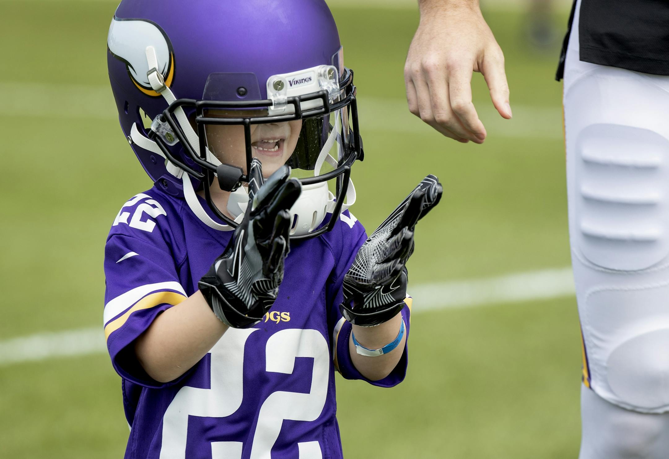 Kingston Mehok, 5, of White Bear Lake, walked out to the practice field with Minnesota Vikings' Harrison Smith wearing his helmet and gloves.