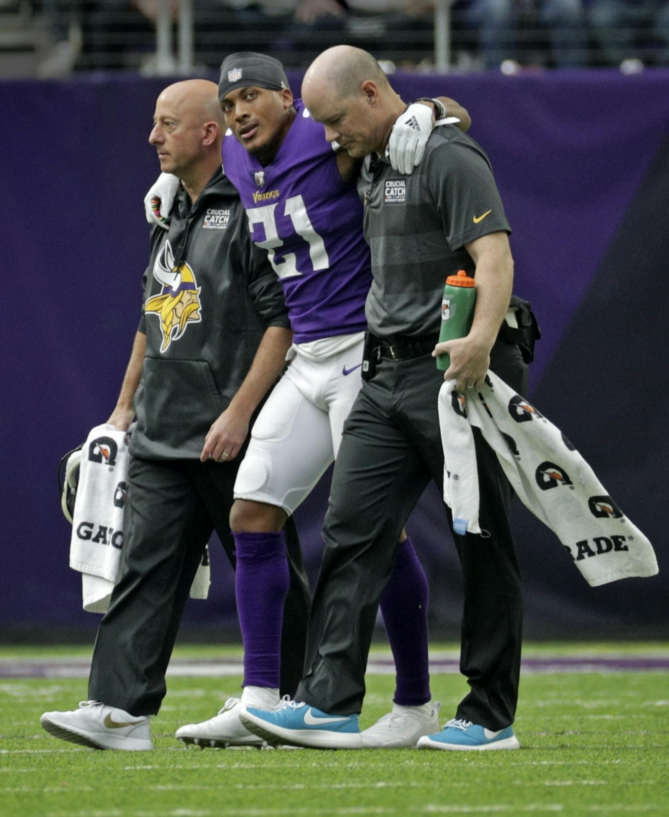 Vikings Mike Hughes is helped off the field after suffering a torn ACL in the 4th quarter.