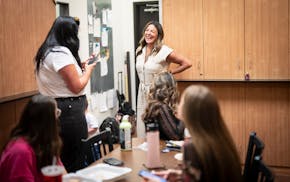 Linda Peterson chats with employees in the break room at Beau Monde Salon in Burnsville. Peterson told the workers that talking about politics and oth