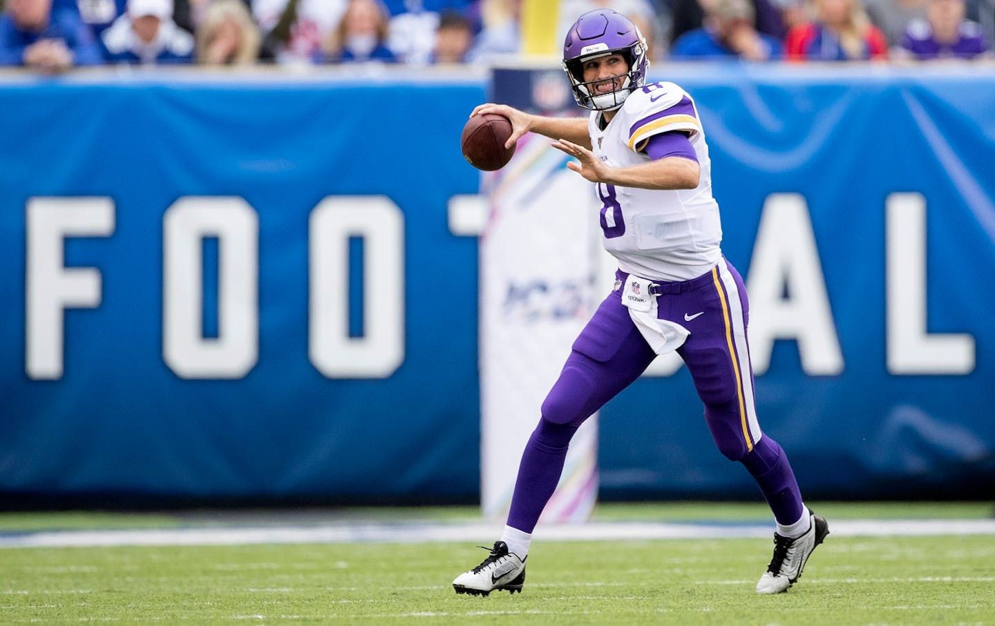 Minnesota Vikings quarterback Kirk Cousins (8) ran out of the pocket in the first quarter.