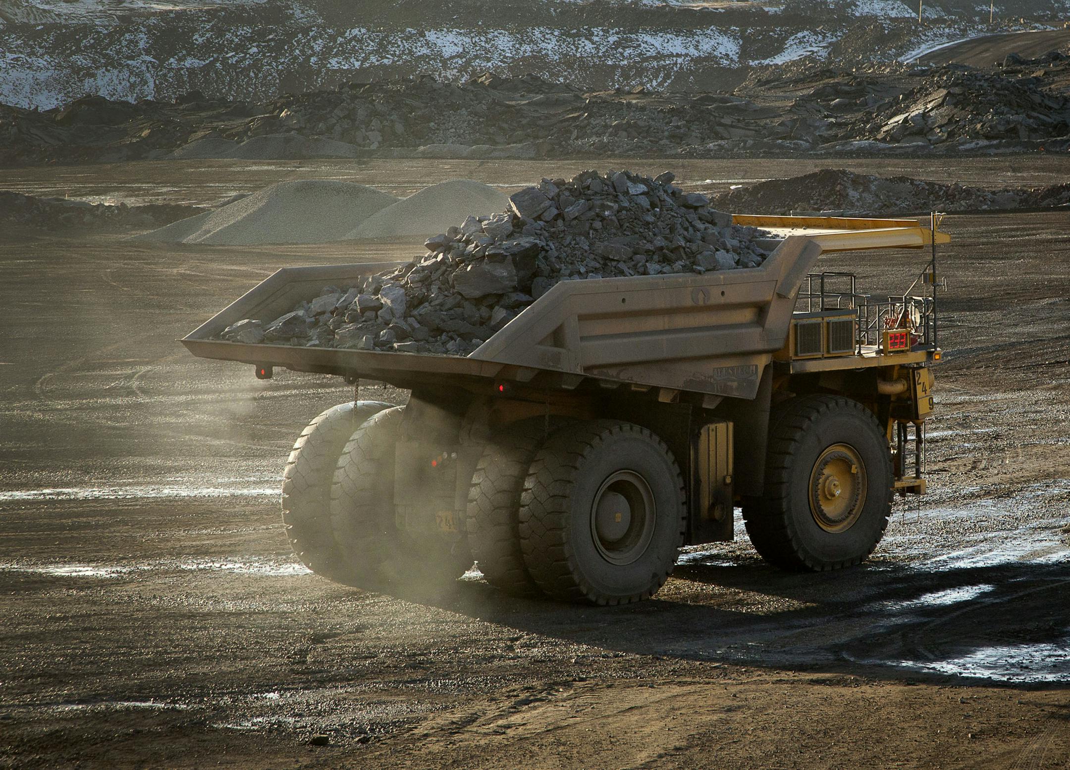 A 240-ton capacity production truck drives out of an open pit mine with a load of taconite heading to the Hibbing Taconite Co. pellet manufacturing plant, operated by Cliff's Natural Resources Inc., in Hibbing, Minnesota, U.S., on Thursday, Jan. 5, 2012. Taconite is a sedimentary rock containing low-grade iron ore, which is eventually processed into small pellets that contain approximately 65 percent iron. Photographer: Ariana Lindquist/Bloomberg ORG XMIT: 136631014