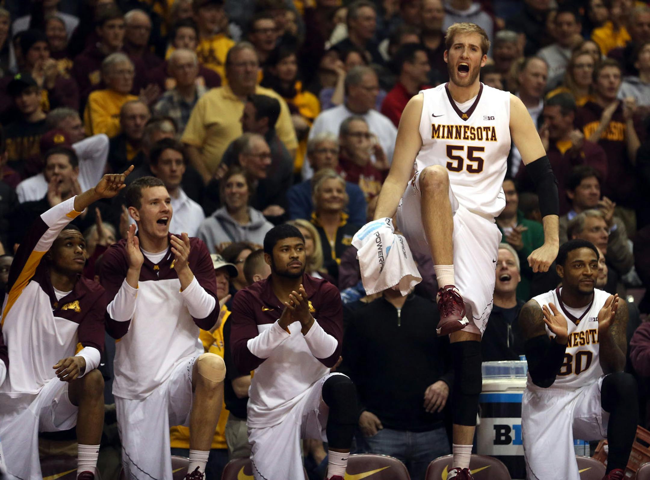 Gopher Elliot Eliason celebrated on the bench as the Gophers made their free throws during the second half