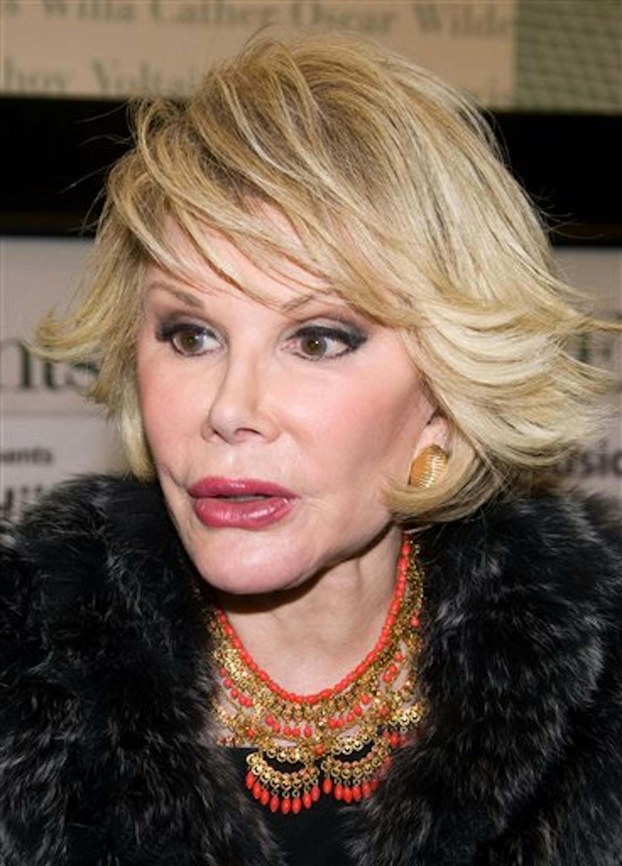 FILE - In this Jan. 29, 2009 file photo, comedian Joan Rivers signs her book "Men Are Stupid And They Like Big Boobs" at the Lincoln Square Barnes & Noble bookstore in New York. (AP Photo/Charles Sykes, file)
