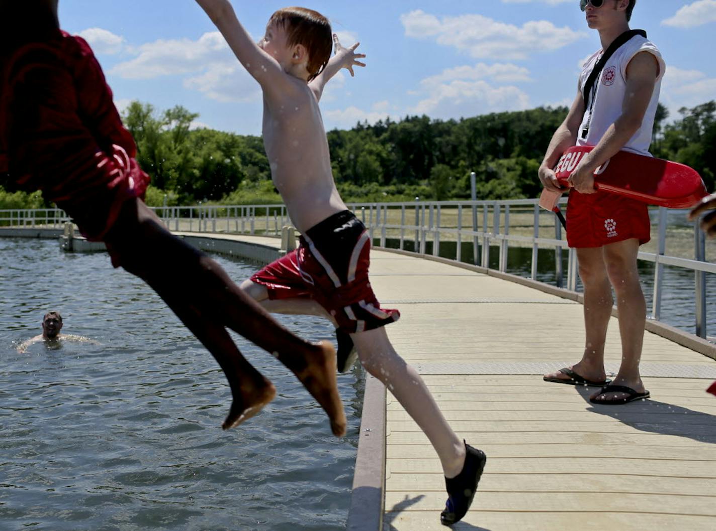 Life Guard Luke Riveness kept an eye on activity in the water at Wirth Lake in Theodore Wirth Park Wednesday in Minneapolis. The number of non-boating drownings is down drastically this year compared to last, including at Wirth Lake where a 6-year-old boy drowned last year.