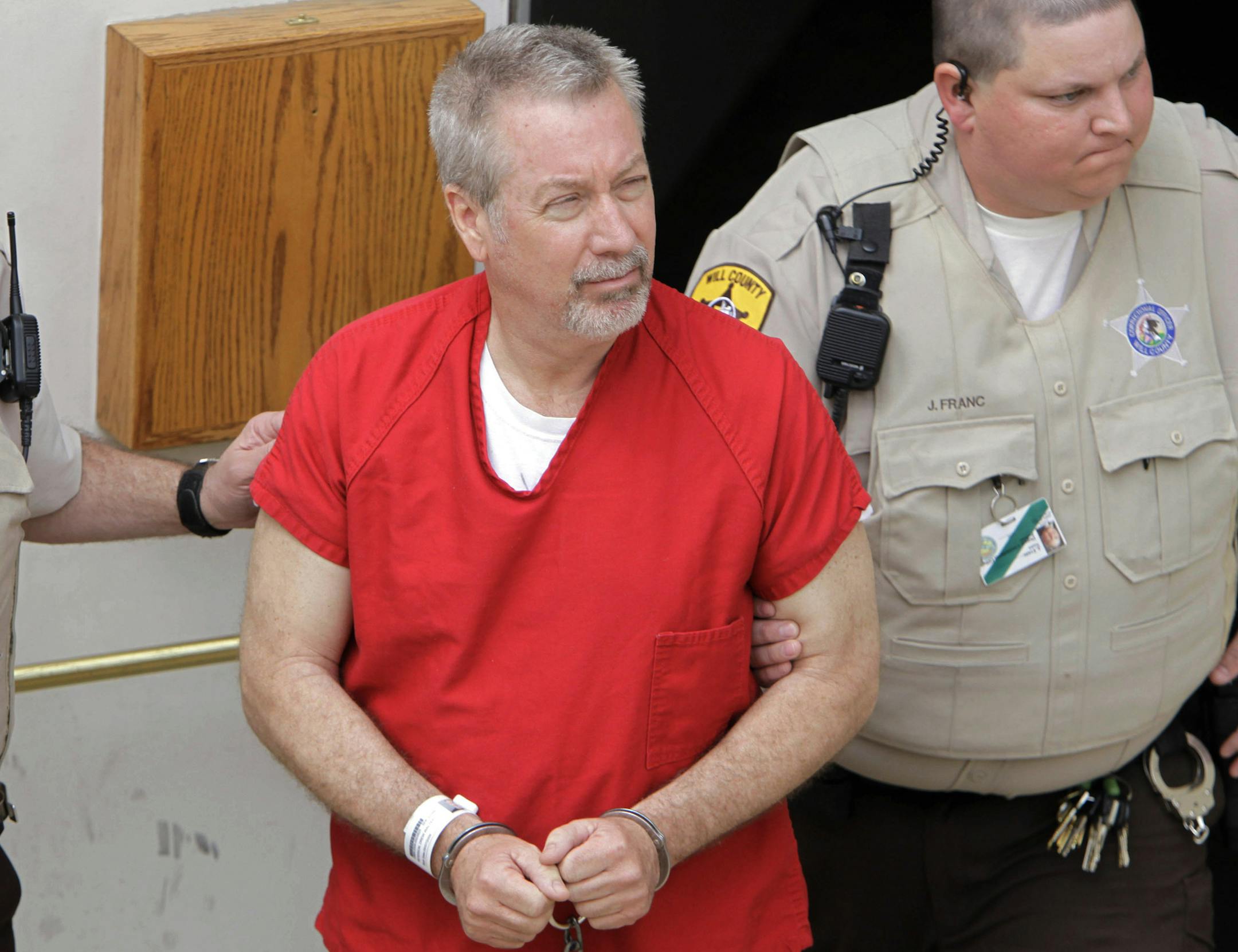 FILE - In this May 8, 2009 file photo, former Bolingbrook, Ill., police sergeant Drew Peterson leaves the Will County Courthouse in Joliet, Ill., after his arraignment on charges of first-degree murder in the 2004 death of his former wife Kathleen Savio. On Wednesday, Sept. 6, 2012, jurors at Peterson's trial withdrew to begin deliberations on whether Peterson murdered his third wife. (AP Photo/M. Spencer Green, File)