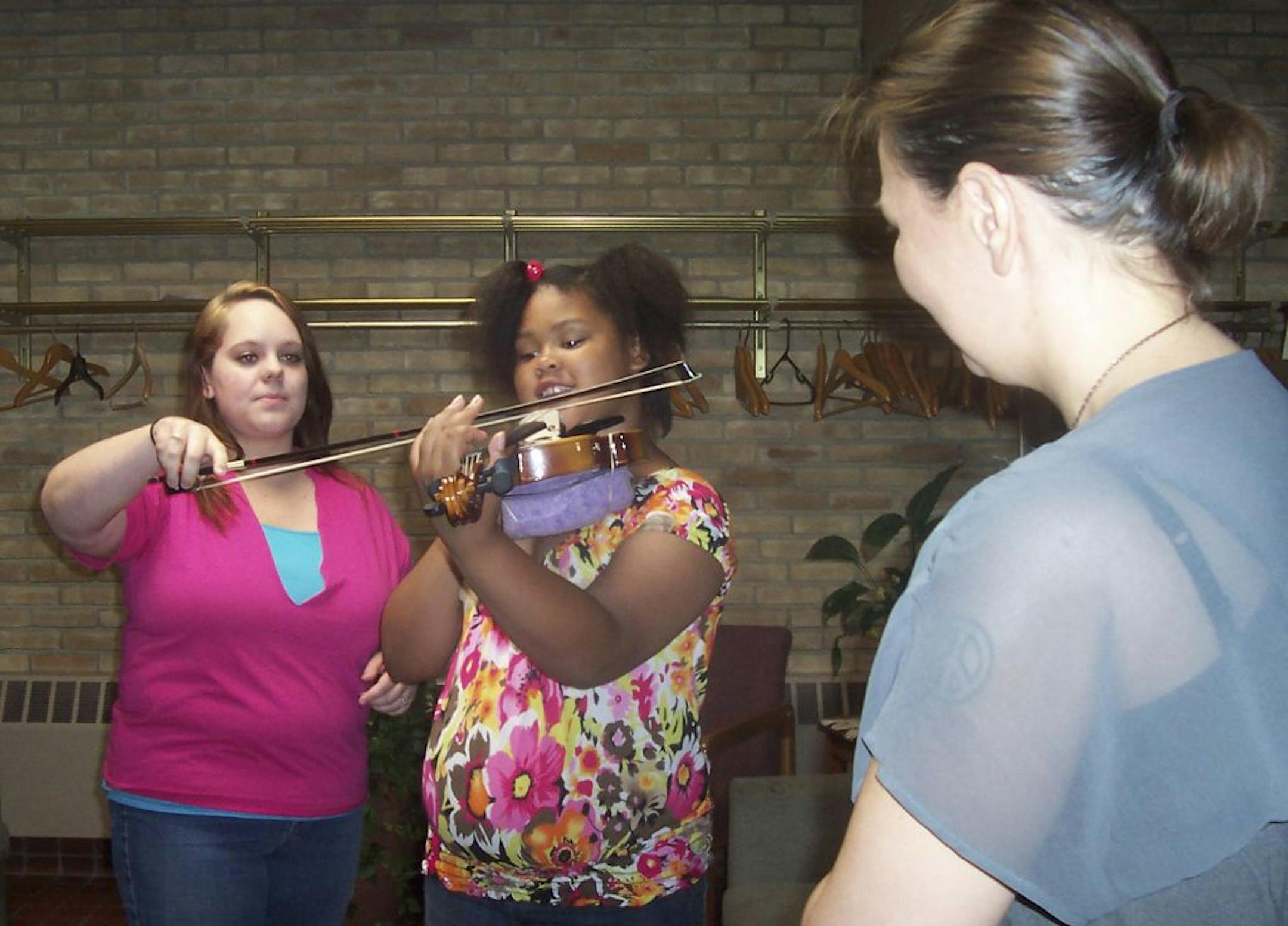 Photo by Erin Adler10-year-old Kayaira Barnes (center) takes weekly violin lessons at a north Minneapolis church from teacher Ellie Fregni through Hopewell North Music Collective. Also pictured is Anna Mills, left, 17, a student of Fregni�s who assists with lessons as an apprentice.
