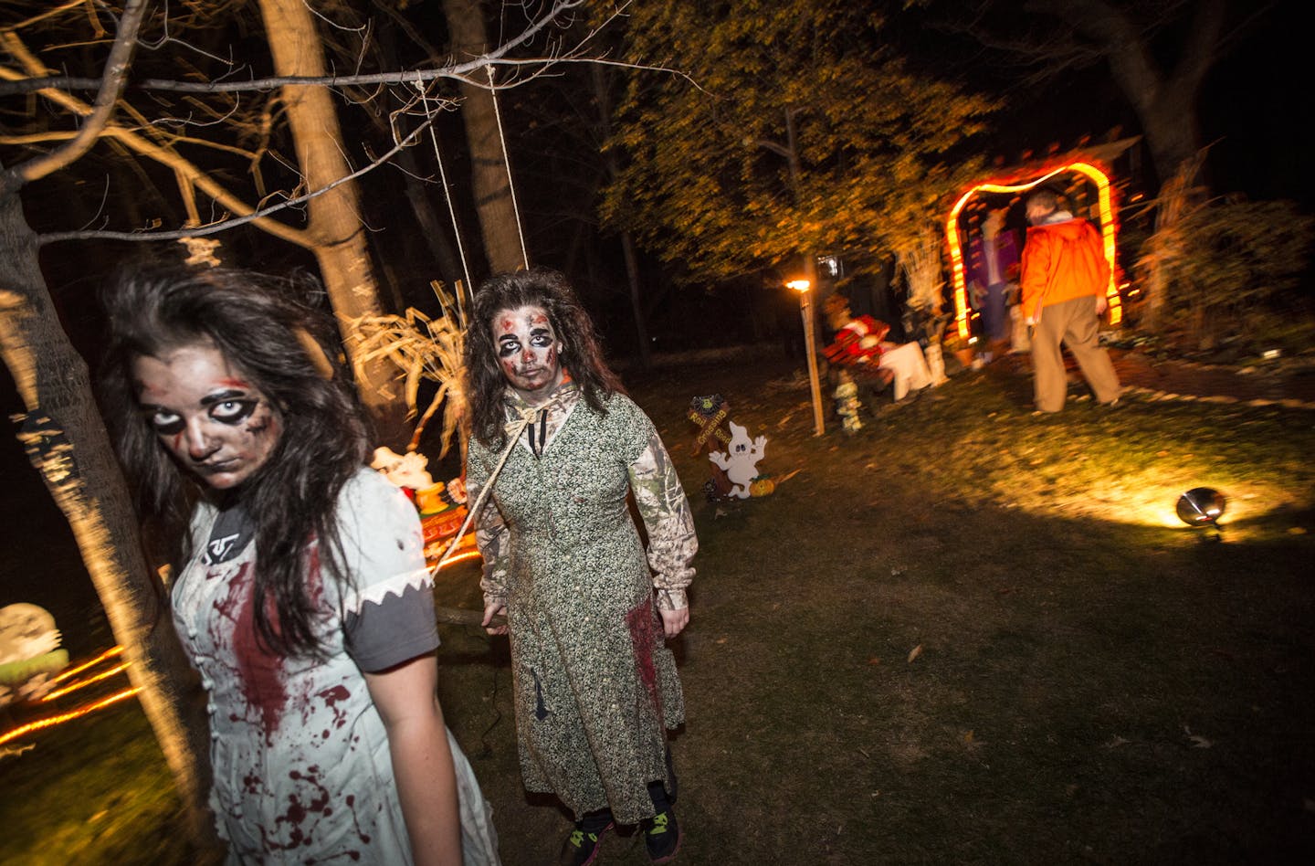 Kelsey Haggard and Sarah Koester walked around in a zombie state dragging a sledge hammer as part of the Orchid Street NW, Andover, Minn., Halloween scene on Wednesday, October 22, 2014. This scene won first place. Fourteen families are competing in the city of Anoka's annual Halloween outdoor decorating contest. ] RENEE JONES SCHNEIDER &#x2022; reneejones@startribune.com