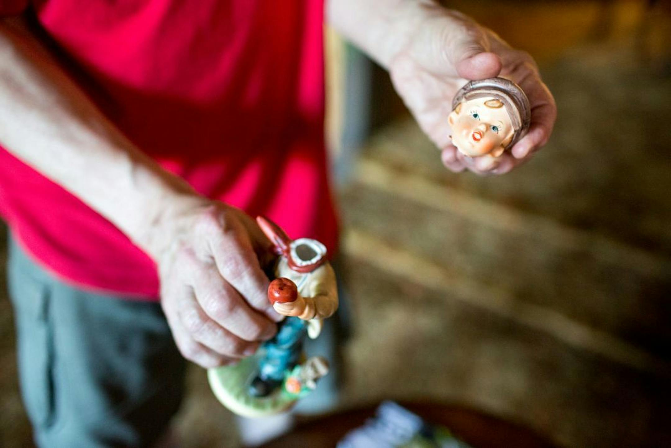 Ron Meyer holds a figurine which fell and broke while the house shook.