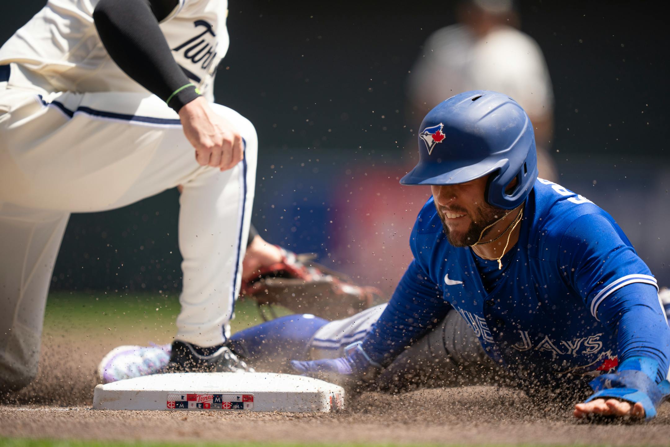 Toronto Blue Jays right fielder George Springer (4) dove safely into third base in the third inning.