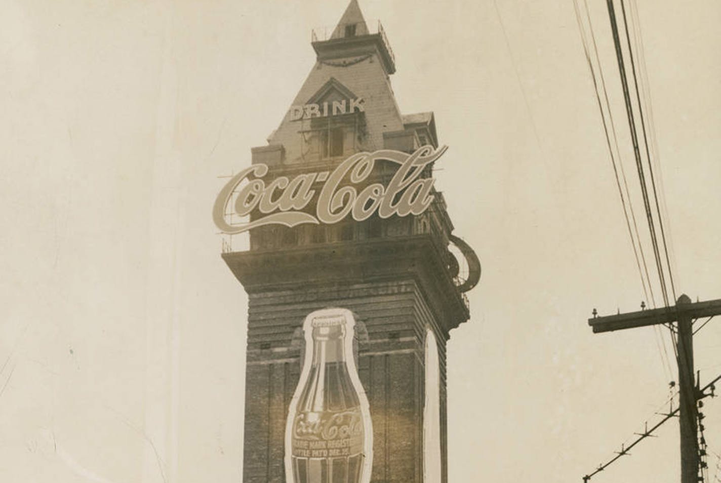 View of the Coca-Cola sign on the tower of the old Exposition Building, which stands 225 feet high. The sign marks the site of the Coca-Cola Bottling Company's new plant on Central Avenue, on the east bank of the Mississippi River across from downtown. The neon bottle is 54 feet high; the lower panels, to be used for civic and national promotions, are 53 feet high; and the neon letters on top are 16 feet high, said to be legible from 3 miles away. The new display tops the previous tallest sign in Chicago by 75 feet. (Courtesy of Hennepin County Library)