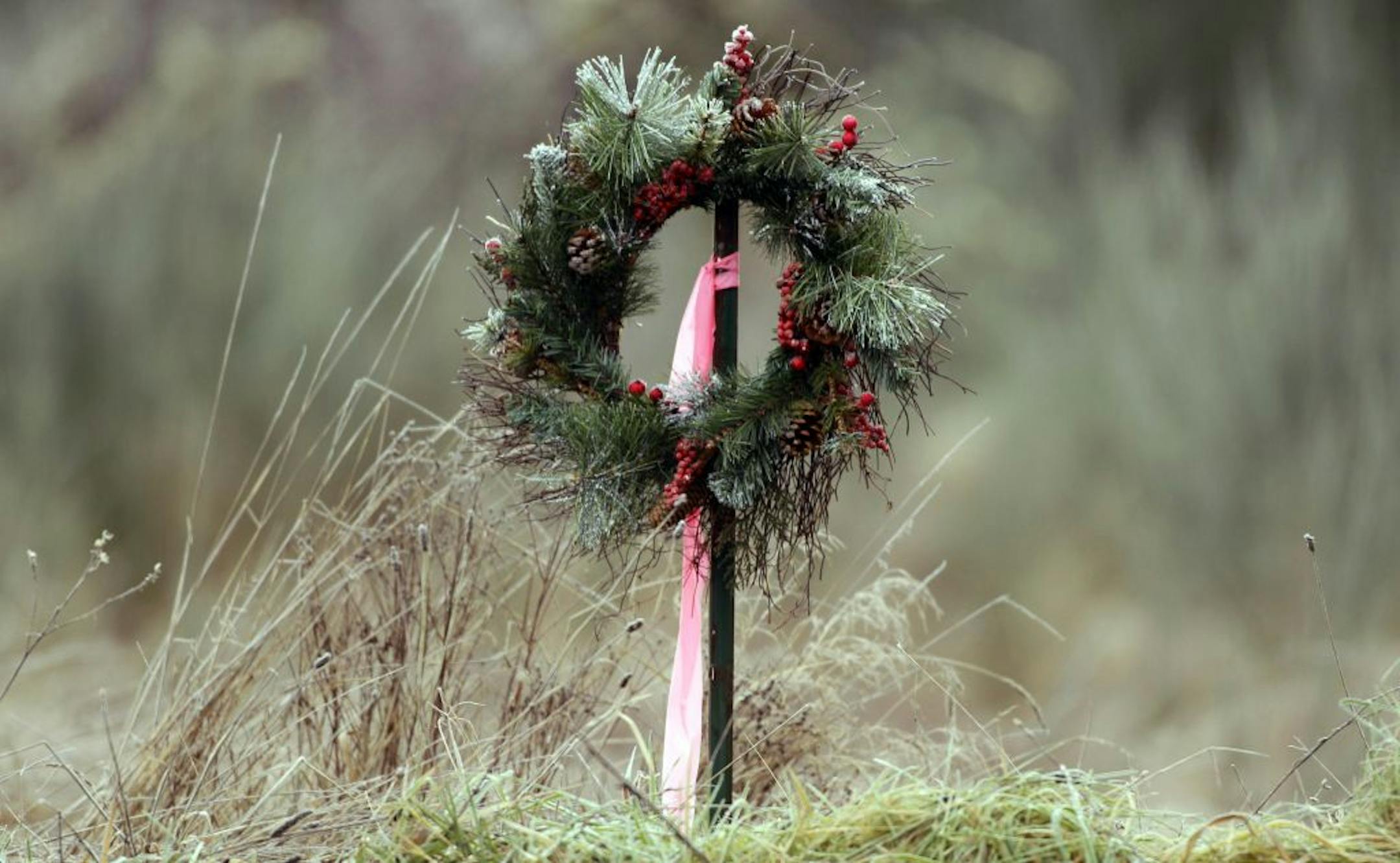 A holiday wreath is shown, Wednesday, Dec. 14, 2011, near a checkpoint leading to the area where two U.S. Army helicopters crashed Monday night on Joint Base Lewis-McChord in Washington state. Four Army aviators were killed in the crash.