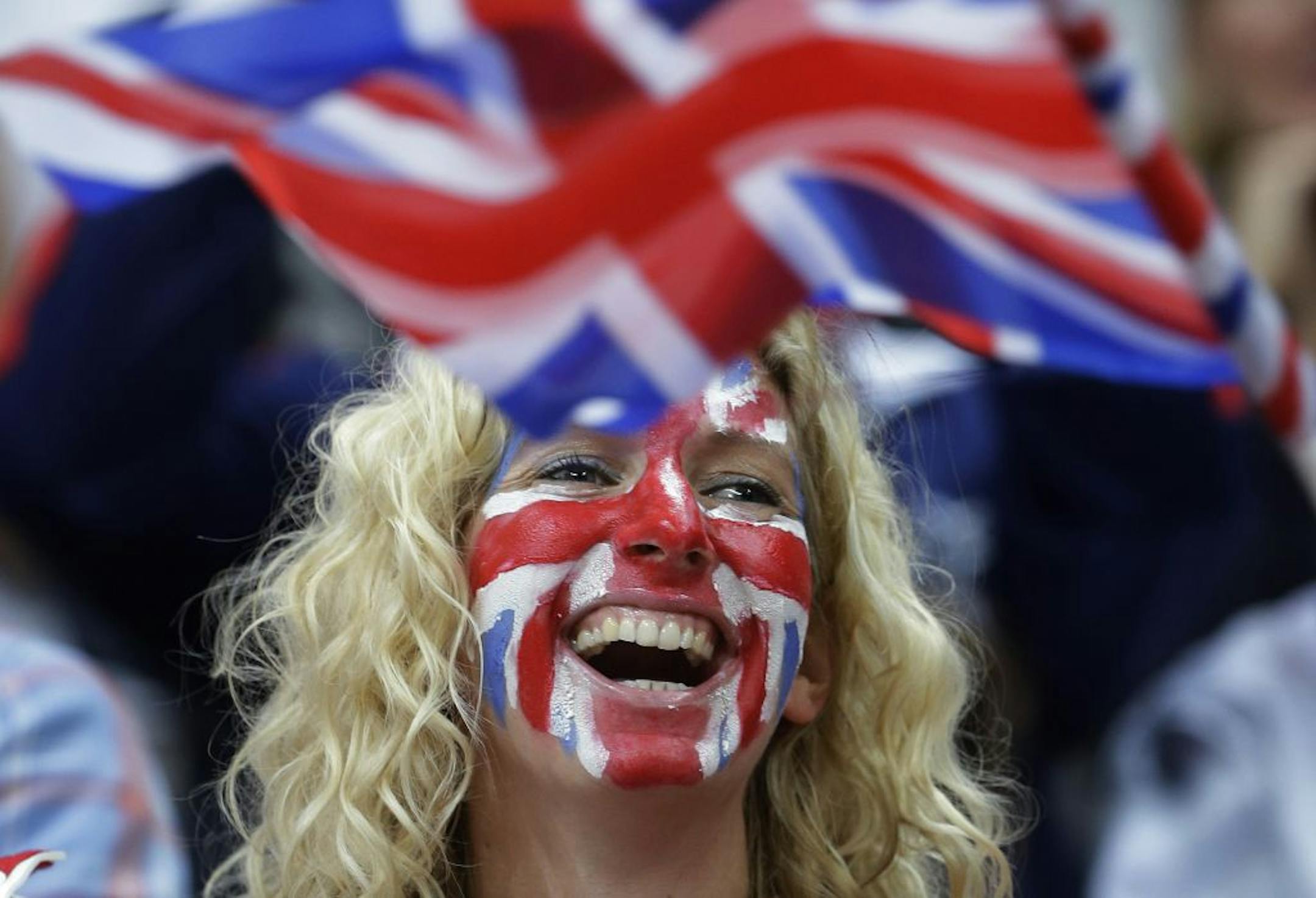 A fan watches a preliminary men's basketball game between Australia and Great Britain at the 2012 Summer Olympics, Saturday, Aug. 4, 2012, in London.