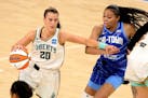 New York Liberty guard Sabrina Ionescu, left, tries to get past Chicago Sky guard Stephanie Watts, right, during a WNBA basketball game Sunday, May 23