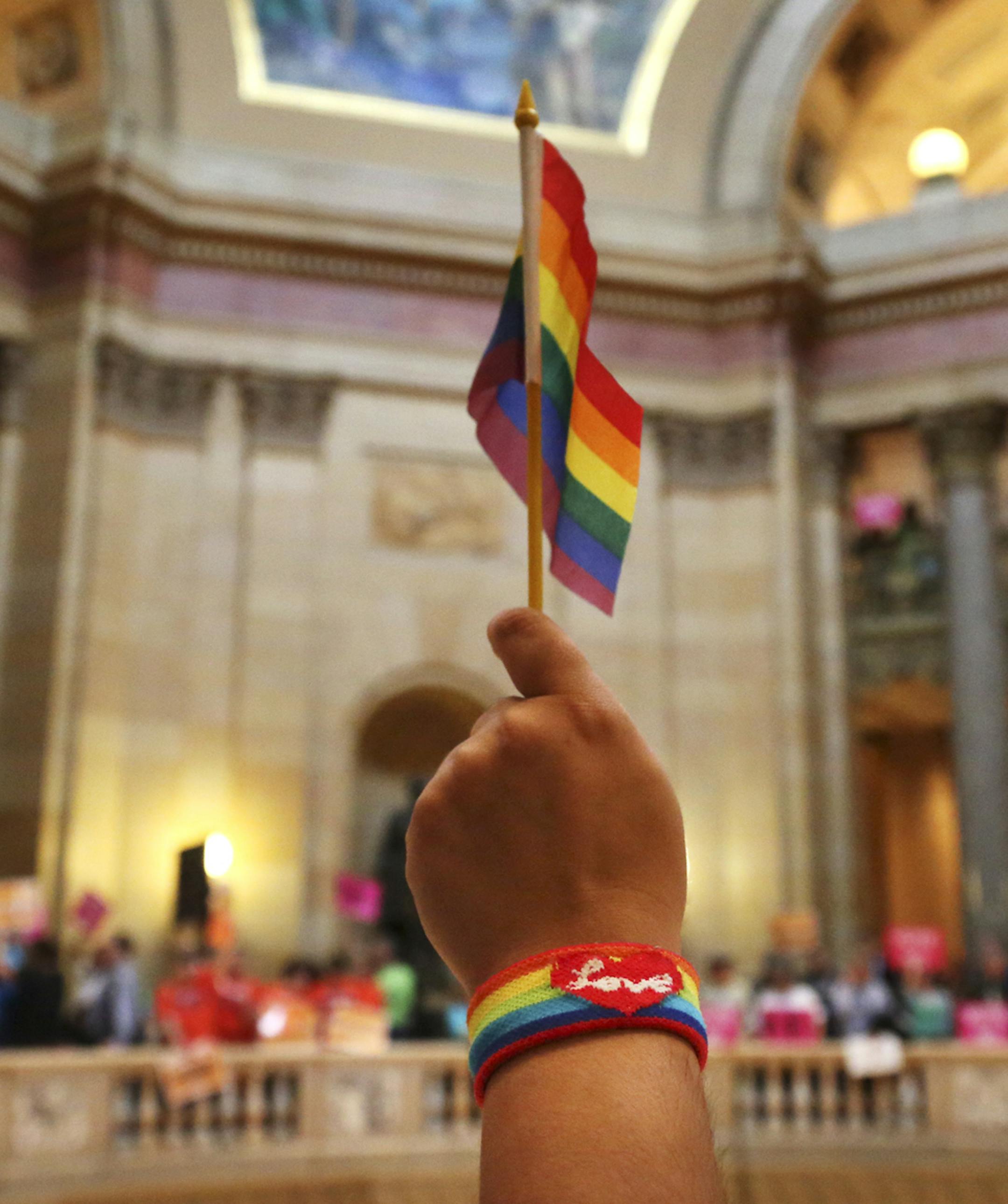 Heidi Garrido of Coon Rapids who is not gay but is a supporter of gay marriage, waved the pride flag befire the Minnesota House convened to debate and vote a measure that would legalize same-sex marriage in the stateThursday, May 9, at the State Capitol in St. Paul, MN. ](DAVID JOLES/STARTRIBUNE) djoles@startribune.com In a historic vote, a bipartisan coalition in the Minnesota House passed a measure that would legalize same-sex marriage in the state. The dramatic vote came after a passionate, h
