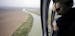 FILE - In this Tuesday, Feb. 24, 2015, aerial file photo, a U.S. Customs and Border Protection Air and Marine agent looks out along the Rio Grande on 