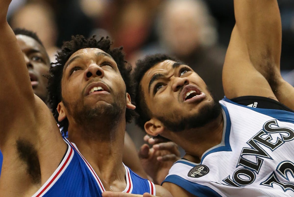 Timberwolves center Karl-Anthony Towns, right, fouled 76ers center Jahlil Okafor as they were going for a rebound under the Wolves' net in the second 