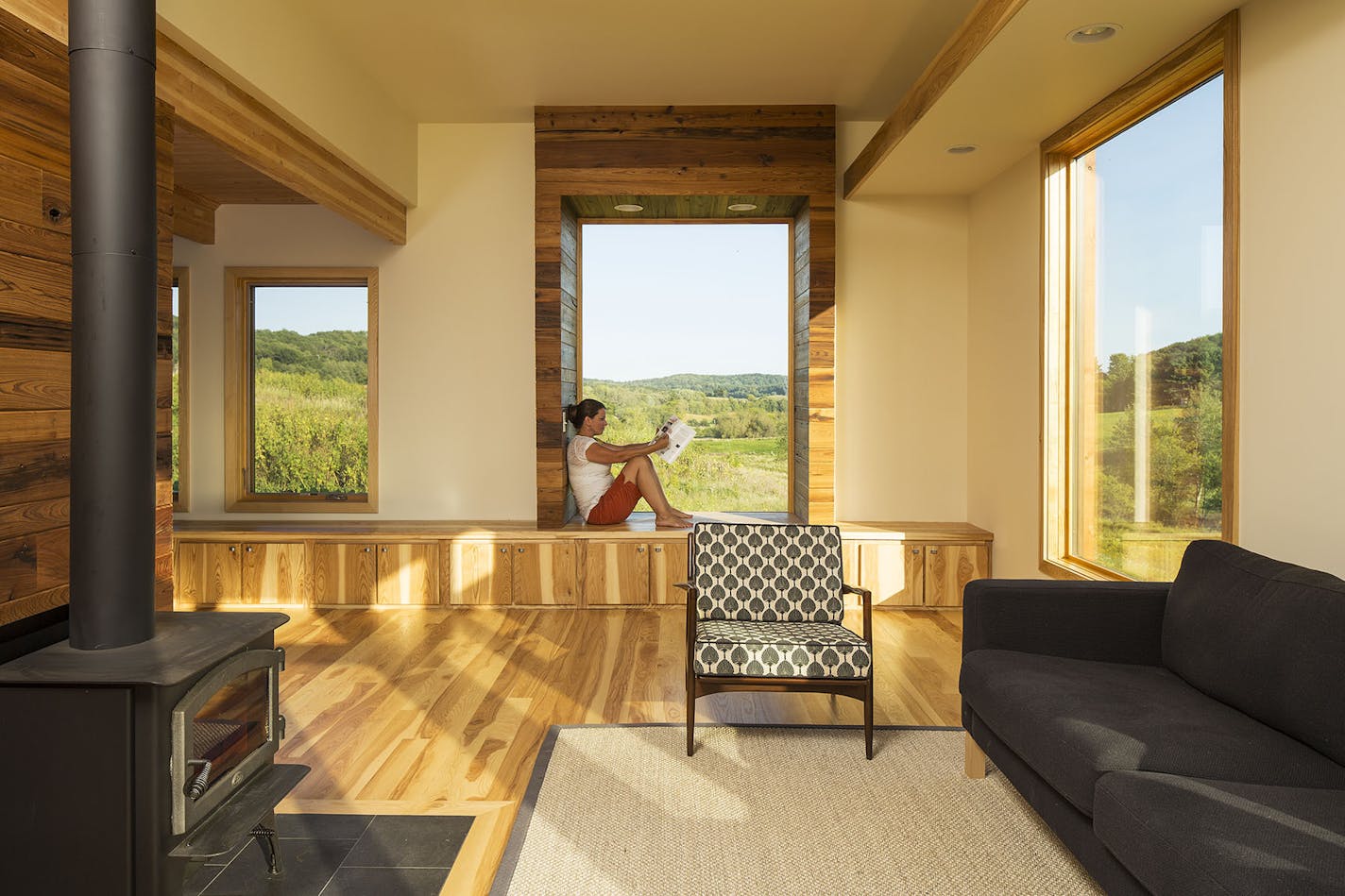 Architect Meghan Kell Cornell relaxed in a window box with a valley view from the western Wisconsin retreat she designed for Myles and Sue Jacob.