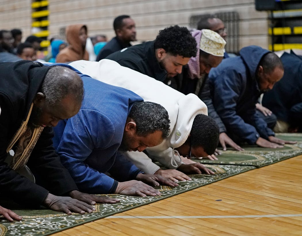 Mohamed Omar, second from left, prays with fellow worshipers during Ramadan at Dar Al-Farooq Islamic Center in Bloomington. Omar’s mind often races to questions of safety as he worries about another attack.