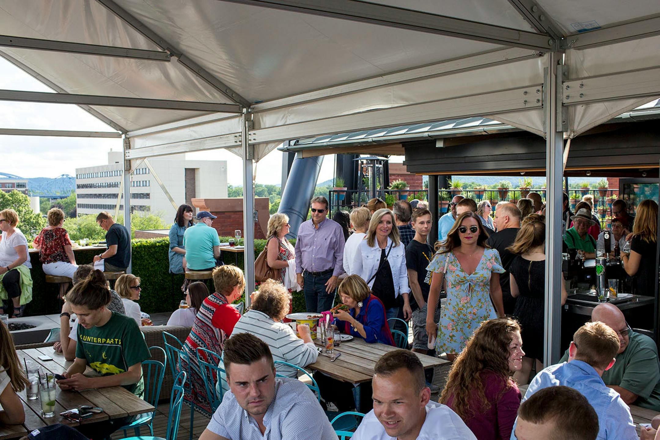 People enjoy the open-air rooftop patio at the Charmant Hotel in La Crosse. ] COURTNEY PEDROZA • courtney.pedroza@startribune.com June 22-24, 2017; Wisconsin restaurants, cafes, bars, bakeries and breweries; Dining along the Mississippi River.