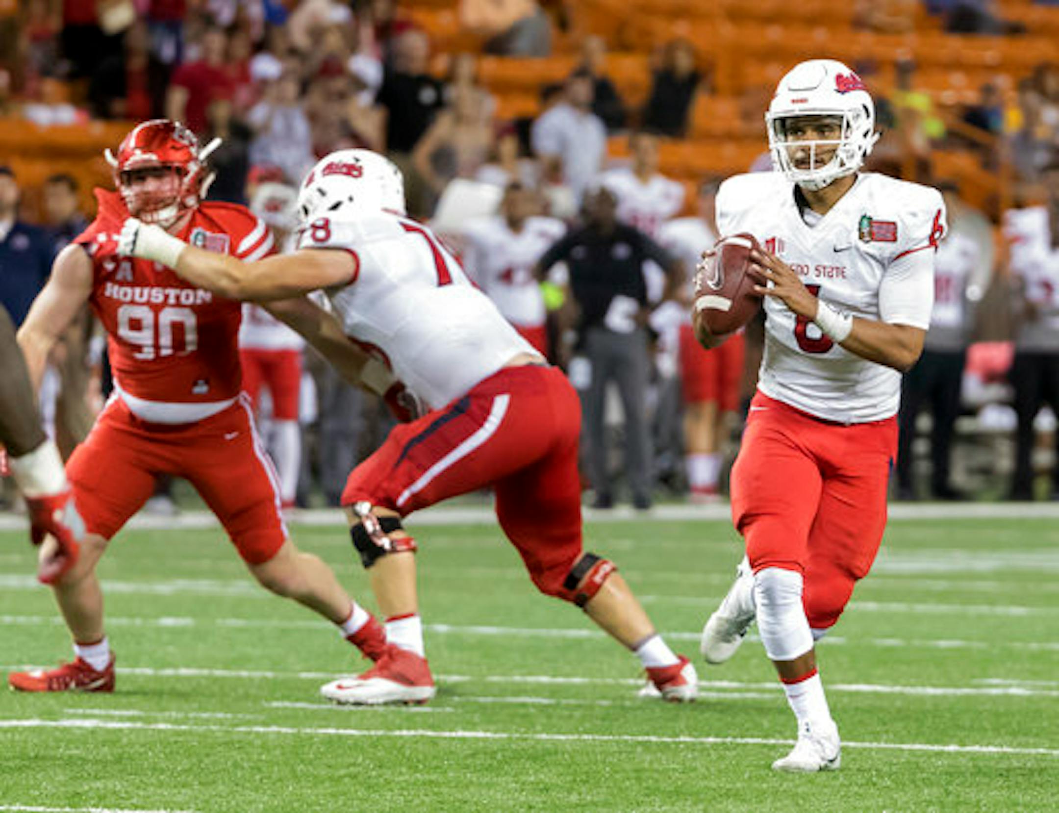 Fresno State quarterback Marcus McMaryion (6) scrambles out of the pocket and looks for an open receiver to pass to in the second half of the Hawaii Bowl NCAA college football game against Houston, Sunday, Dec. 24, 2017, in Honolulu. Fresno State won, 33-27. (AP Photo/Eugene Tanner)
